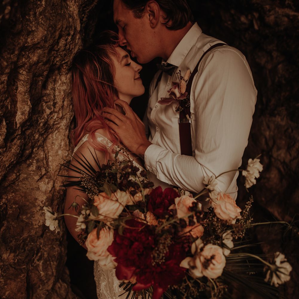 Bride holding a red and white wedding bouquet
