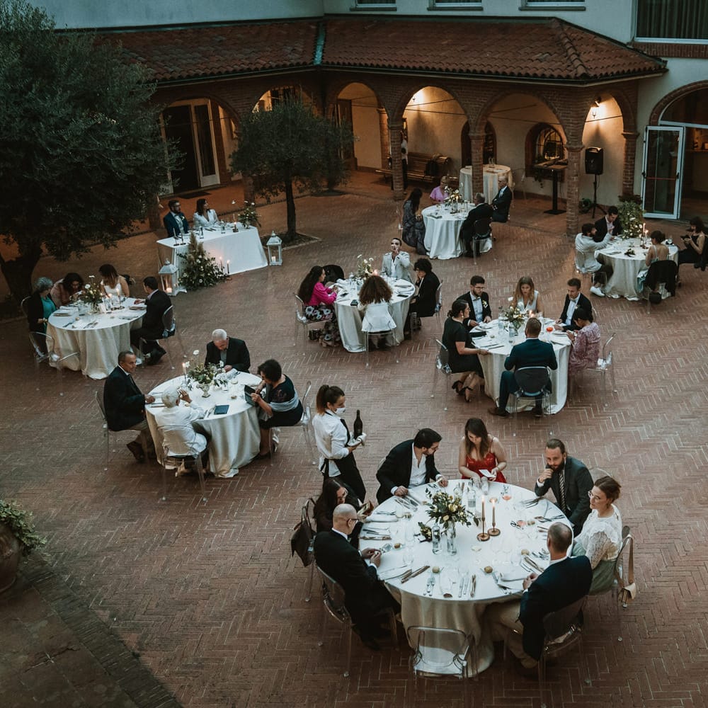 Socially distanced outdoor wedding reception with ghost chairs 