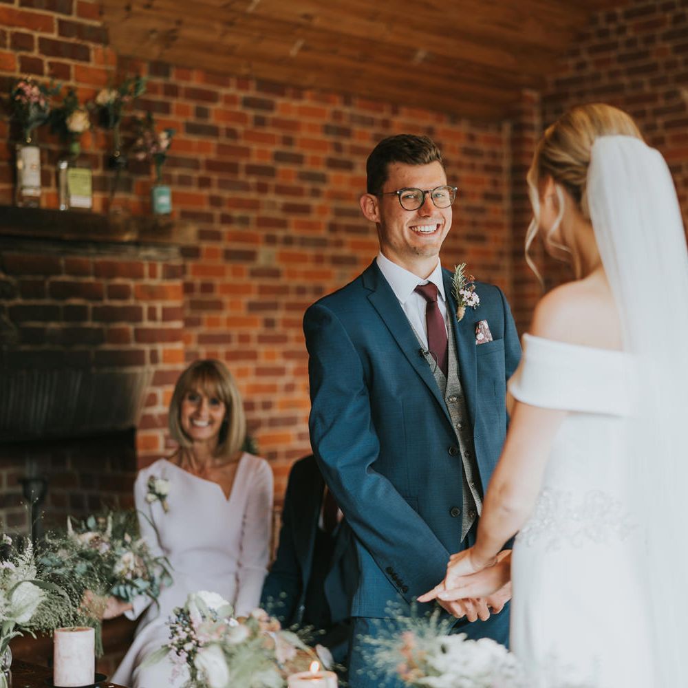 Groom smiles during wedding ceremony