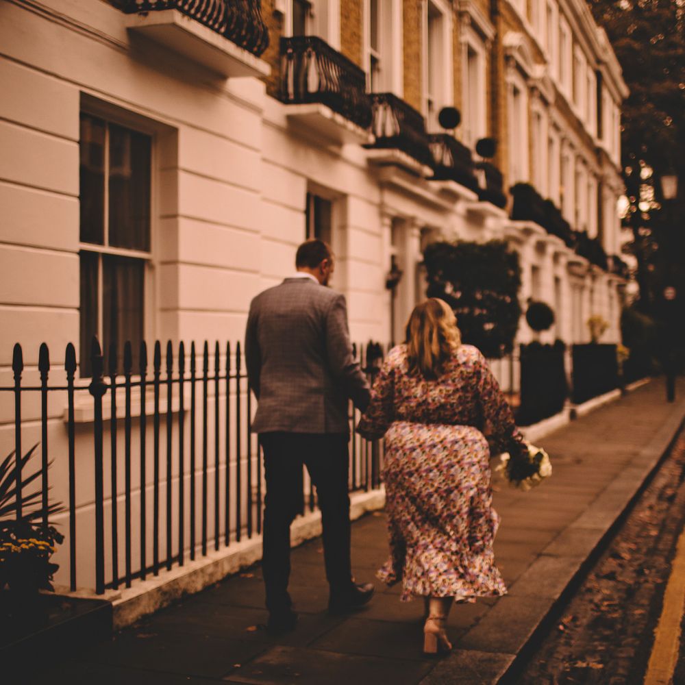 Bride & groom walk through the streets of Chelsea on Autumnal day