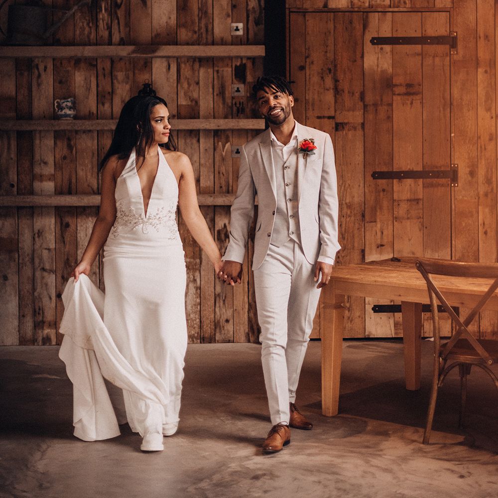 Bride & groom hold hands and walk together 