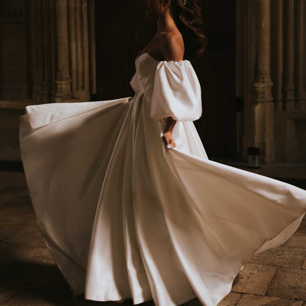 Bride in a Nortier Shallow wedding dress twirling in the shadows at Bodleian Library 