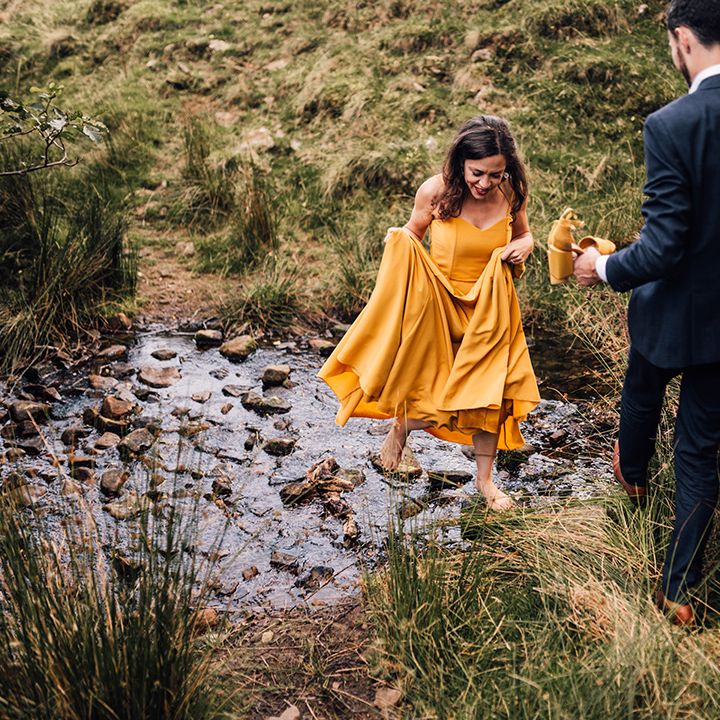 Bride & groom walk hand in hand with one another