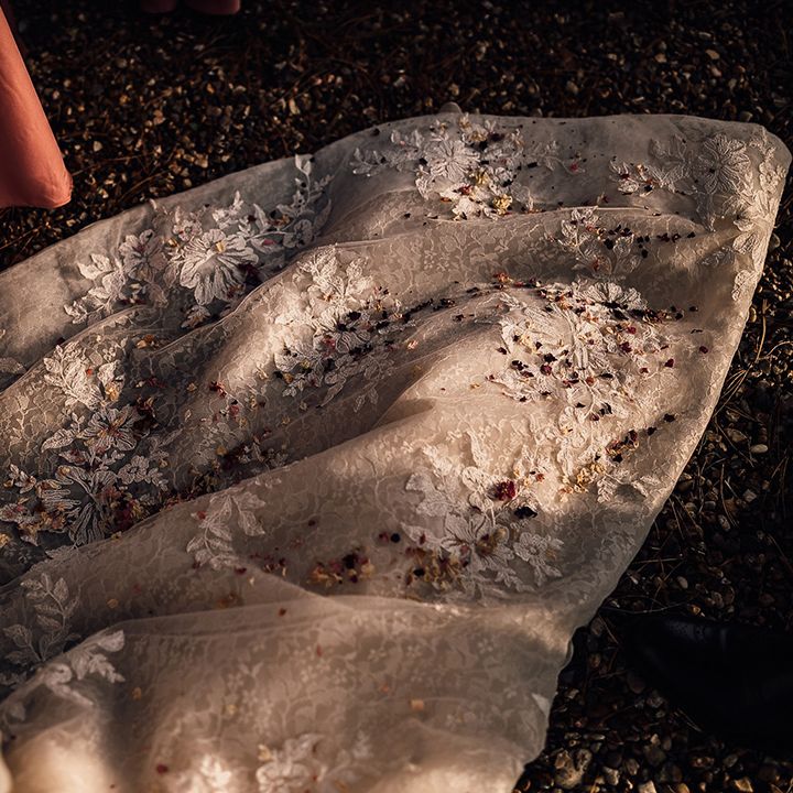 Confetti on the lace train of bride's dress
