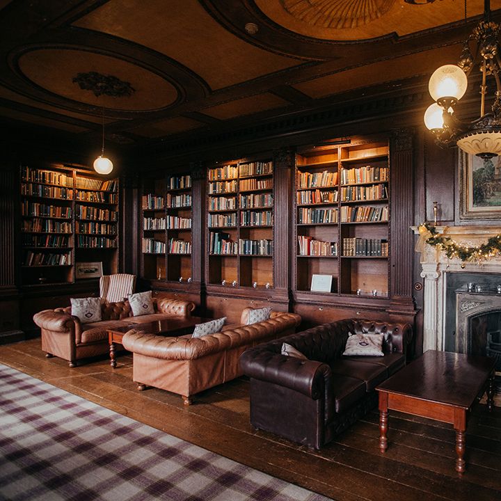 Gosfield Hall room complete with Christmas wreath across fireplace 