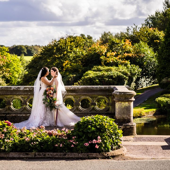 Lesbian wedding at Foxtail Barns wedding venue with brides holding each other