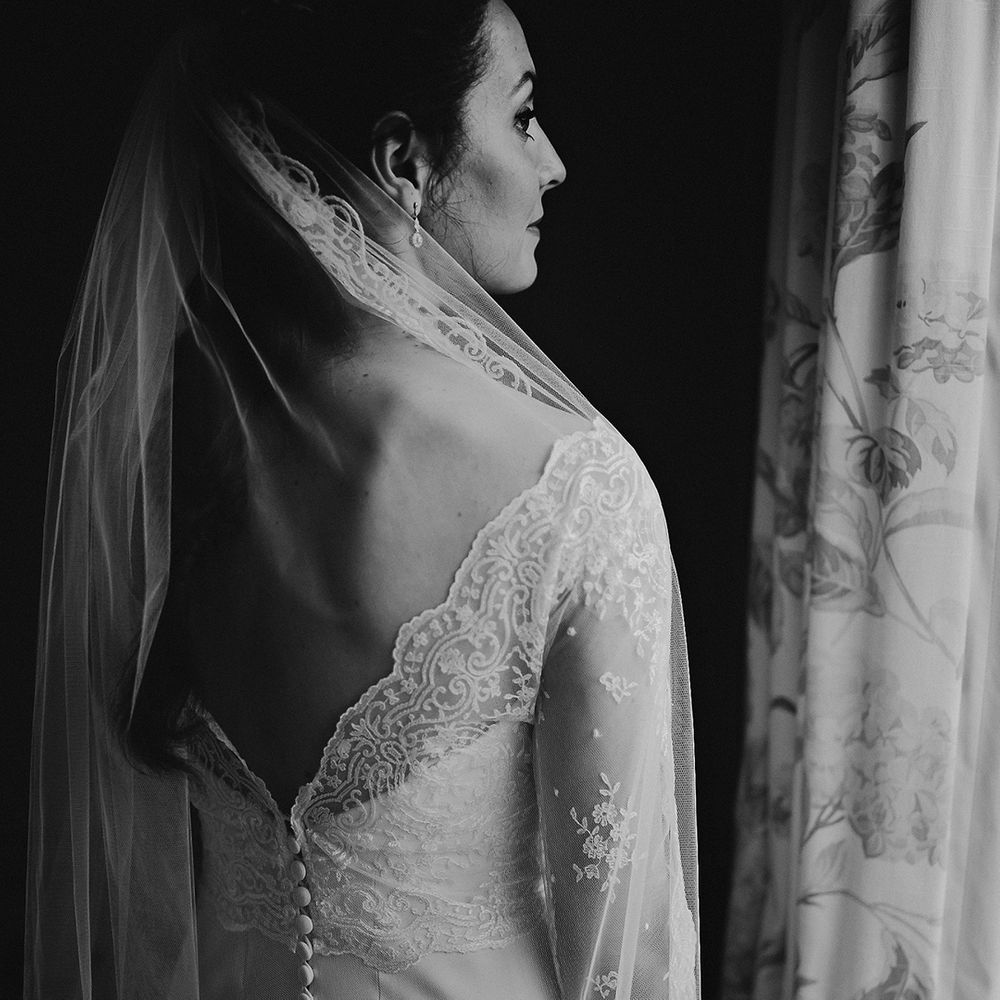 Lace edge wedding dress with sheer lace sleeves and veil for classic and traditional wedding