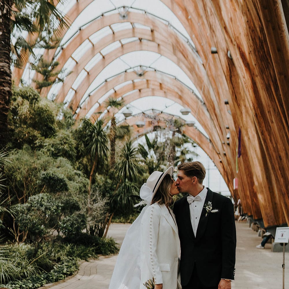 Bride and groom share a kiss at town hall wedding 