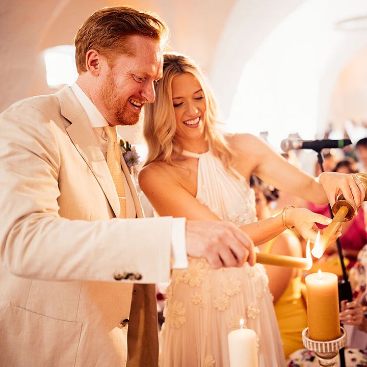 Bride and groom participate in the candle lighting ceremony 