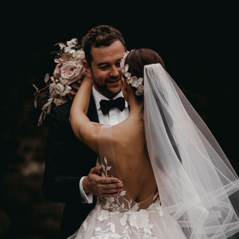 The bride and groom share an intimate embrace for their couple portraits 