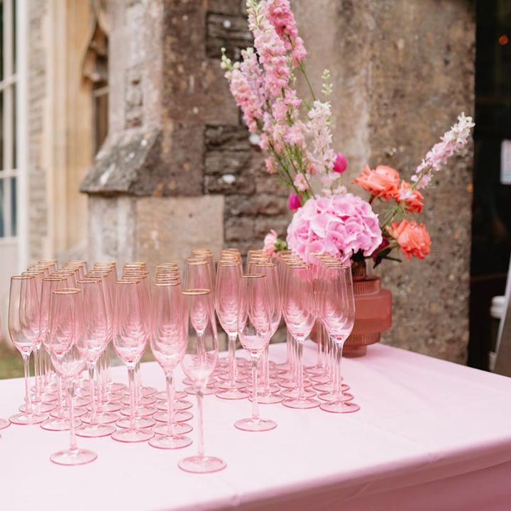 Pink tablecloth with pink champagne glasses for the wedding guests 