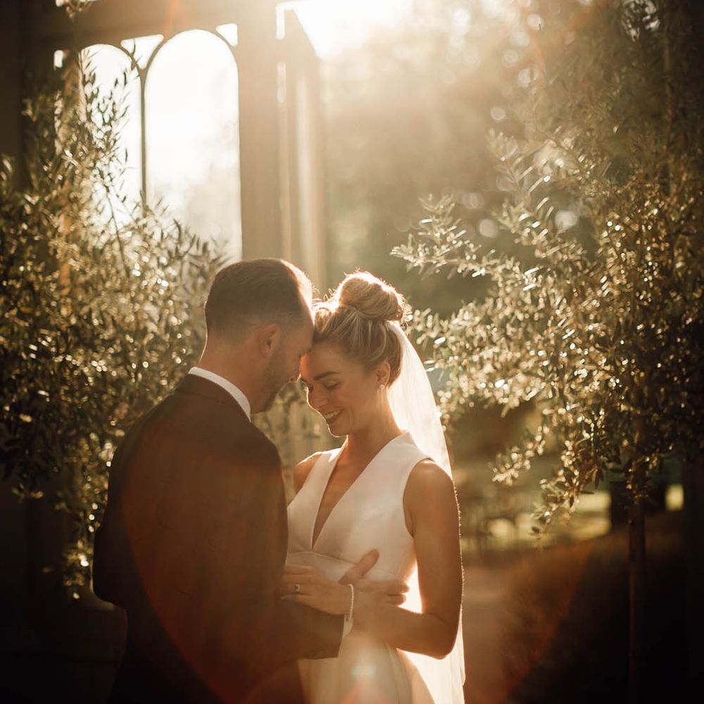 Golden hour wedding photo of the bride and groom at their classic wedding day 