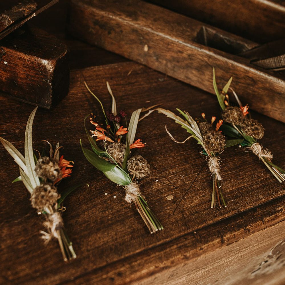 Dried flowers, foliage and orange buttonholes 