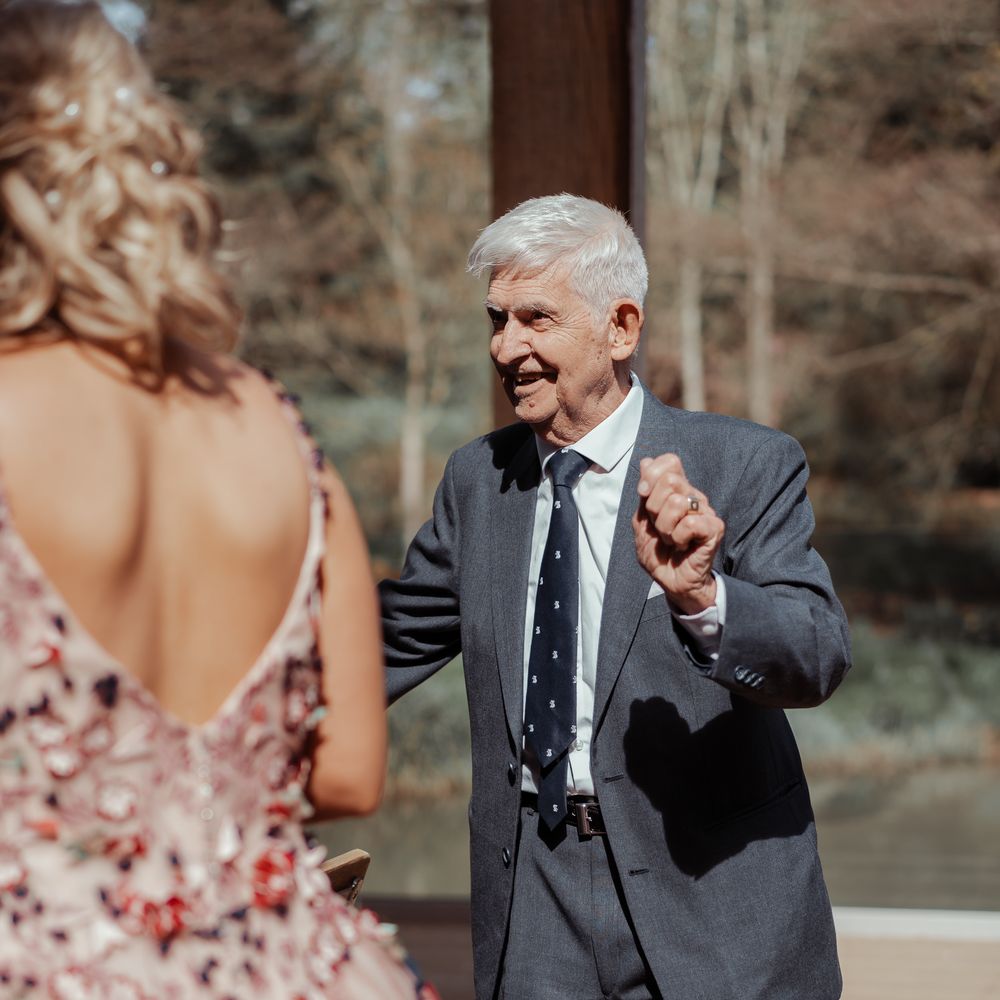 Wedding guest smiles and walks to bride 