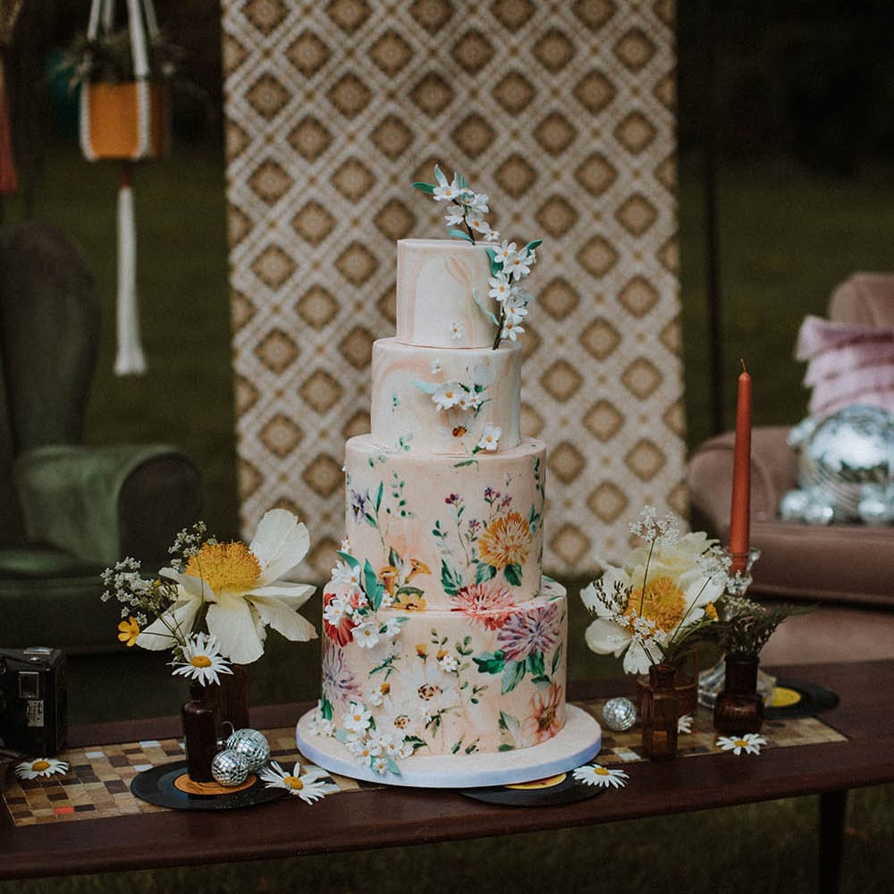 Four tier marble wedding cake with hand illustration decor for sixties wedding inspiration 