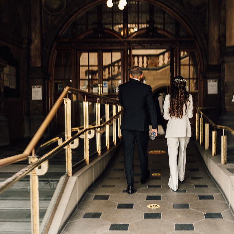 Bride and groom in black and white suits walking into their intimate Sheffield Registry Office wedding 