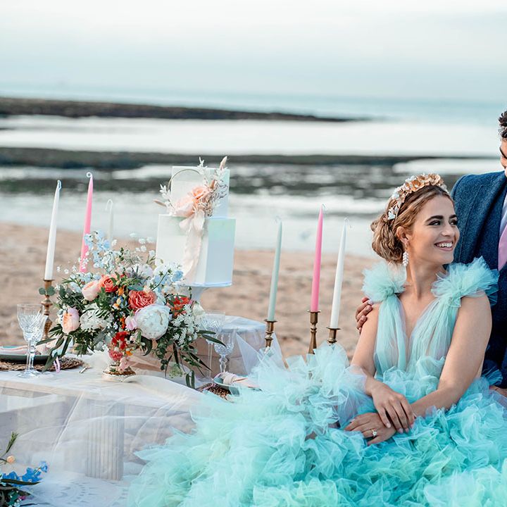 Pastel coloured beach wedding inspiration with bride in a mint green wedding dress and groom a blue wool suit 