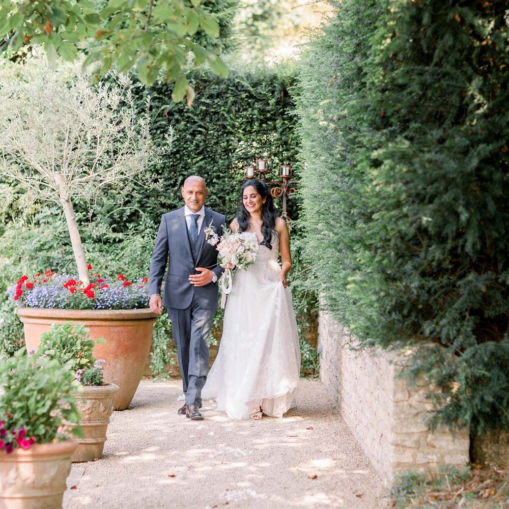 Bride walks to the aisle with her father on her wedding day