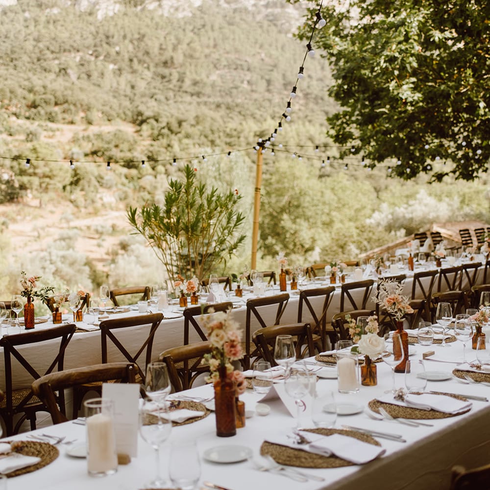 Tables are set with white and pink flowers