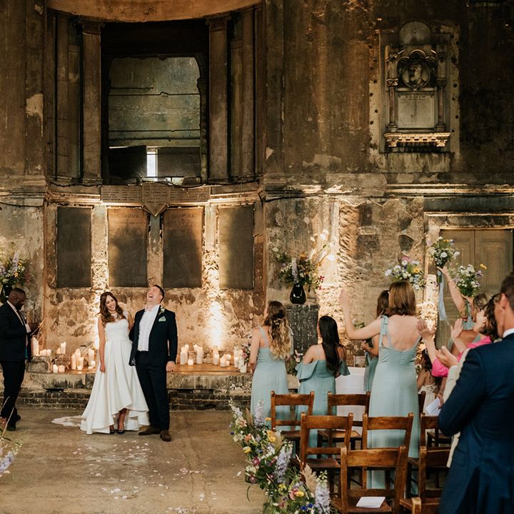 Everyone cheers as the bride and groom are announced as husband and wife in Asylum Chapel wedding venue