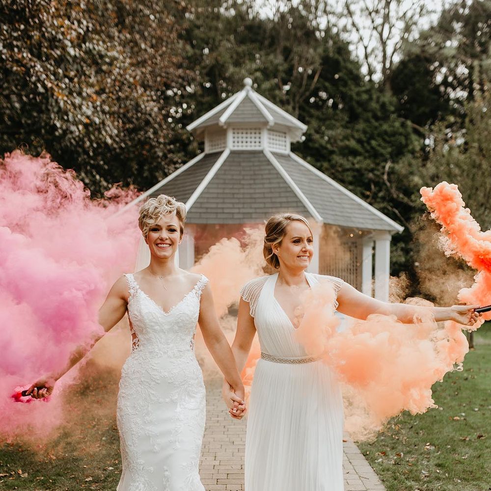 Smoke bomb wedding portrait with two brides at Hayne House wedding venue 