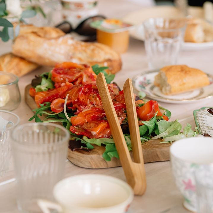 Rocket, salmon and fresh baguettes on a table for wedding guests to eat 
