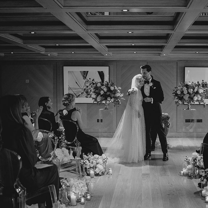 Bride and groom hug as they stand at the altar for their wedding 