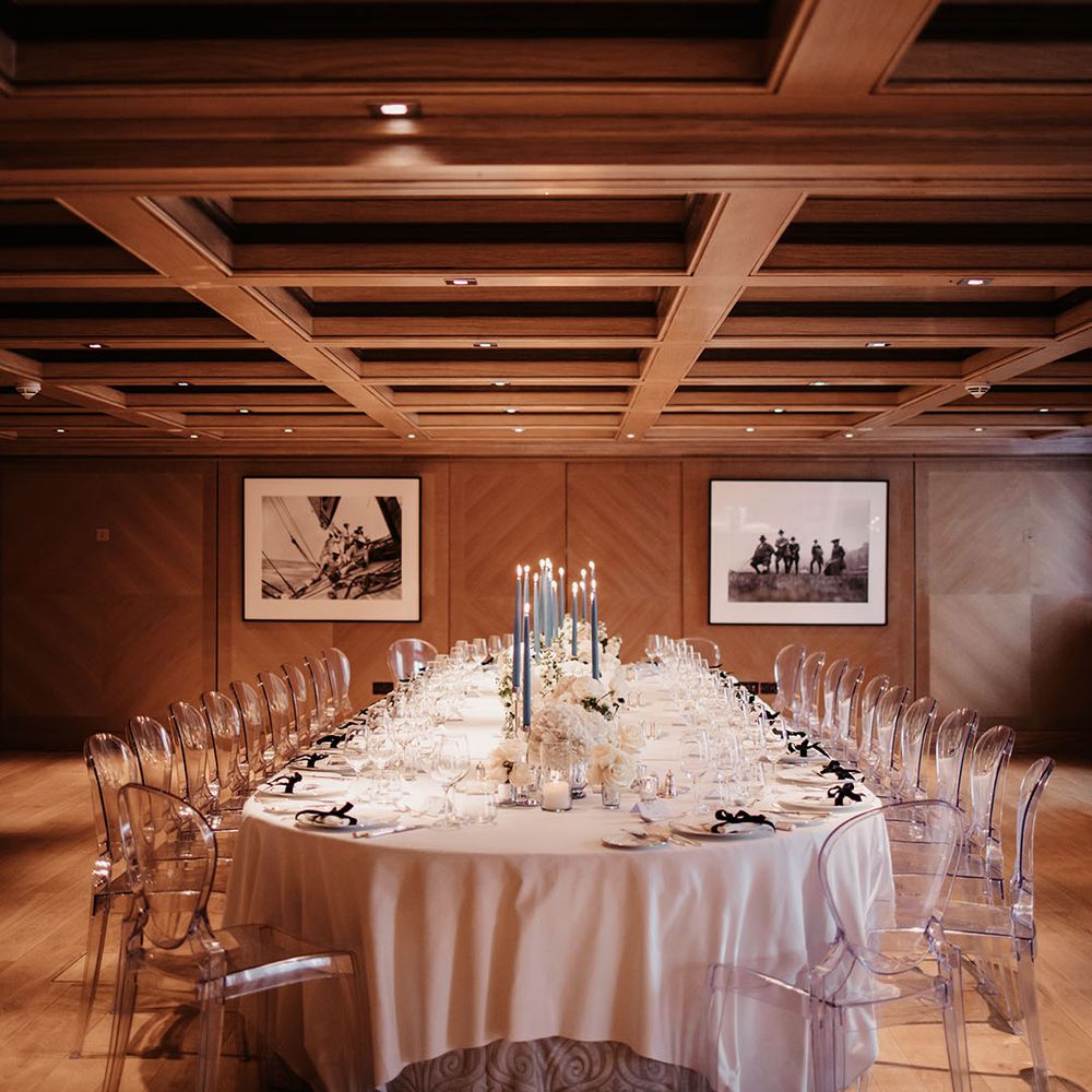 Blue and grey taper candles with white table settings and white flowers