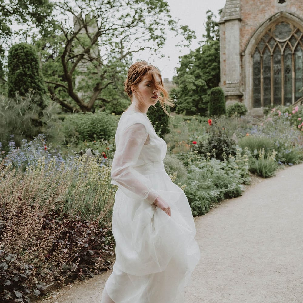 Bride in a wedding dress with long sleeves at Bishop's Palace Wells in Somerset
