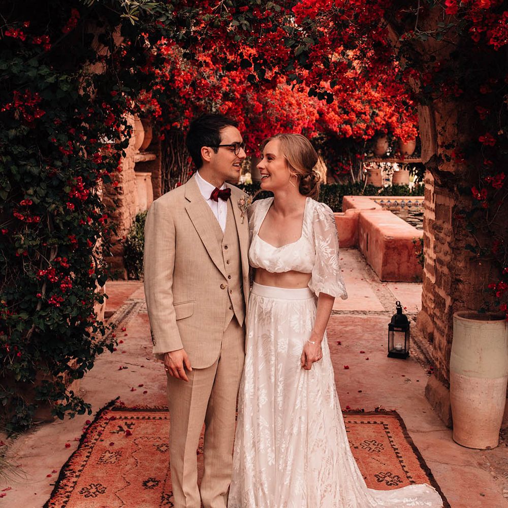 Bride in bridal two piece set with the groom in a cream three piece suit for relaxed summer destination wedding 