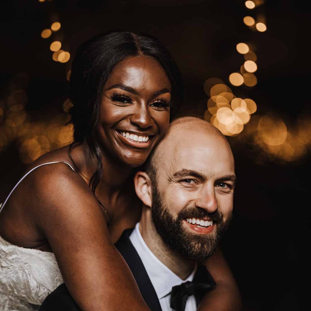 Cute couples wedding portraits - bride and groom embracing and smiling at Lains Barn
