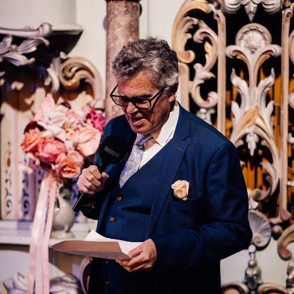 Father of the bride stands up to read out his wedding speech 