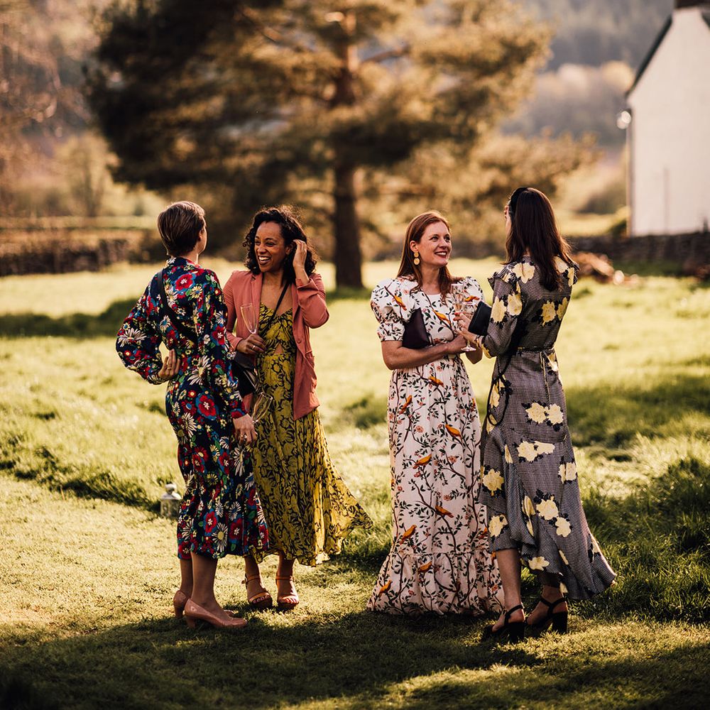 Wedding guests in different colour floral dresses 