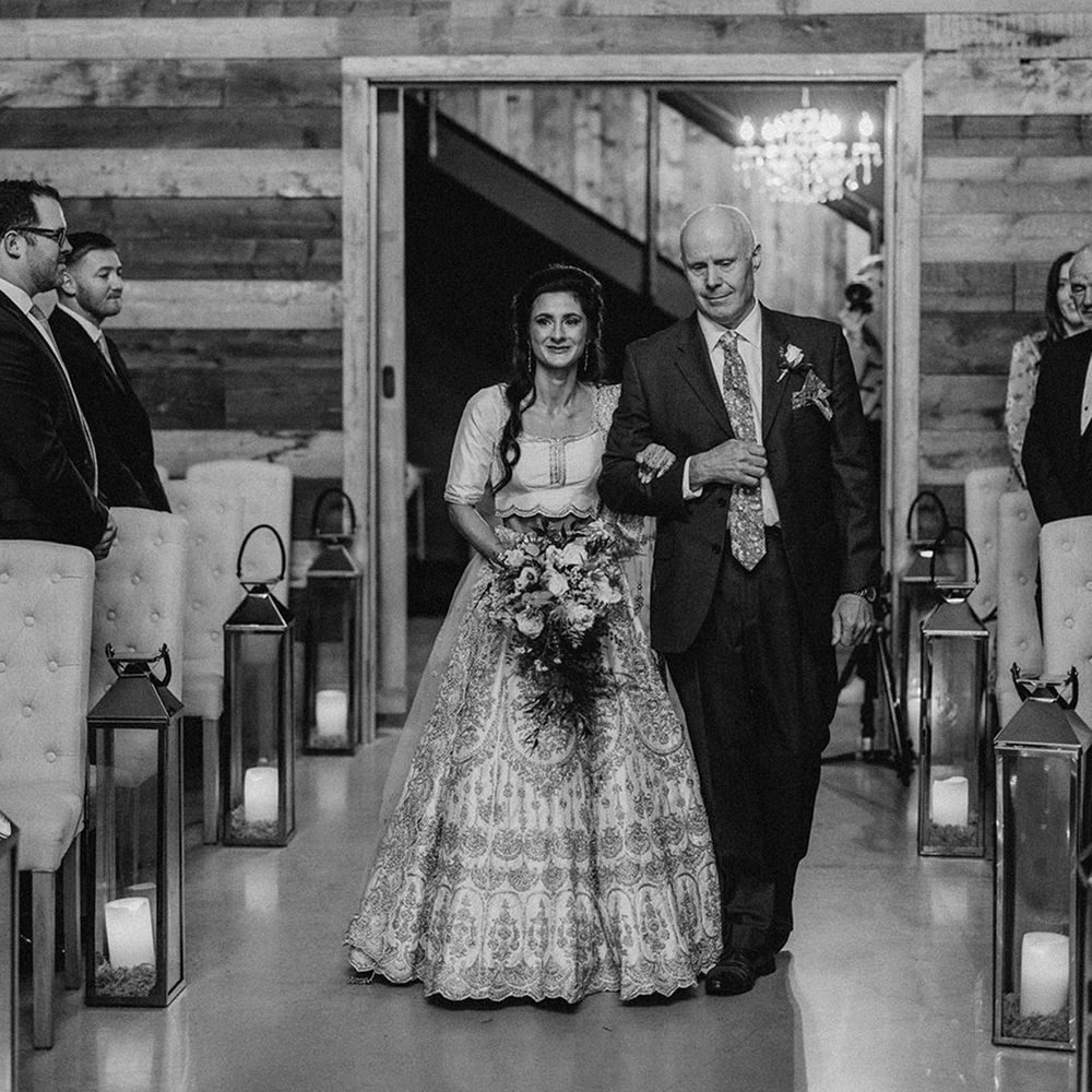 Father of the bride in navy suit walking bride down the aisle at Yorkshire wedding 