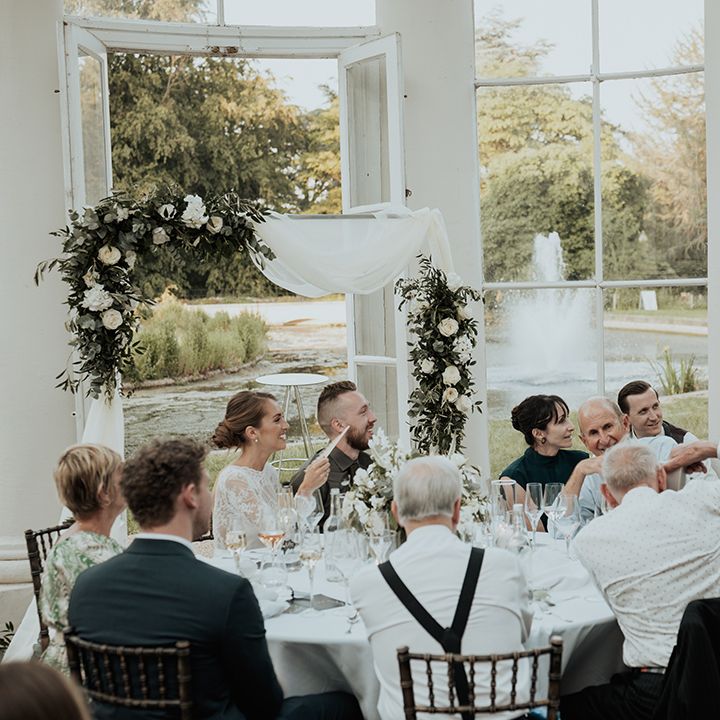 bridesmaid in sage green dress singing during the wedding reception at Gunnersbury Park 