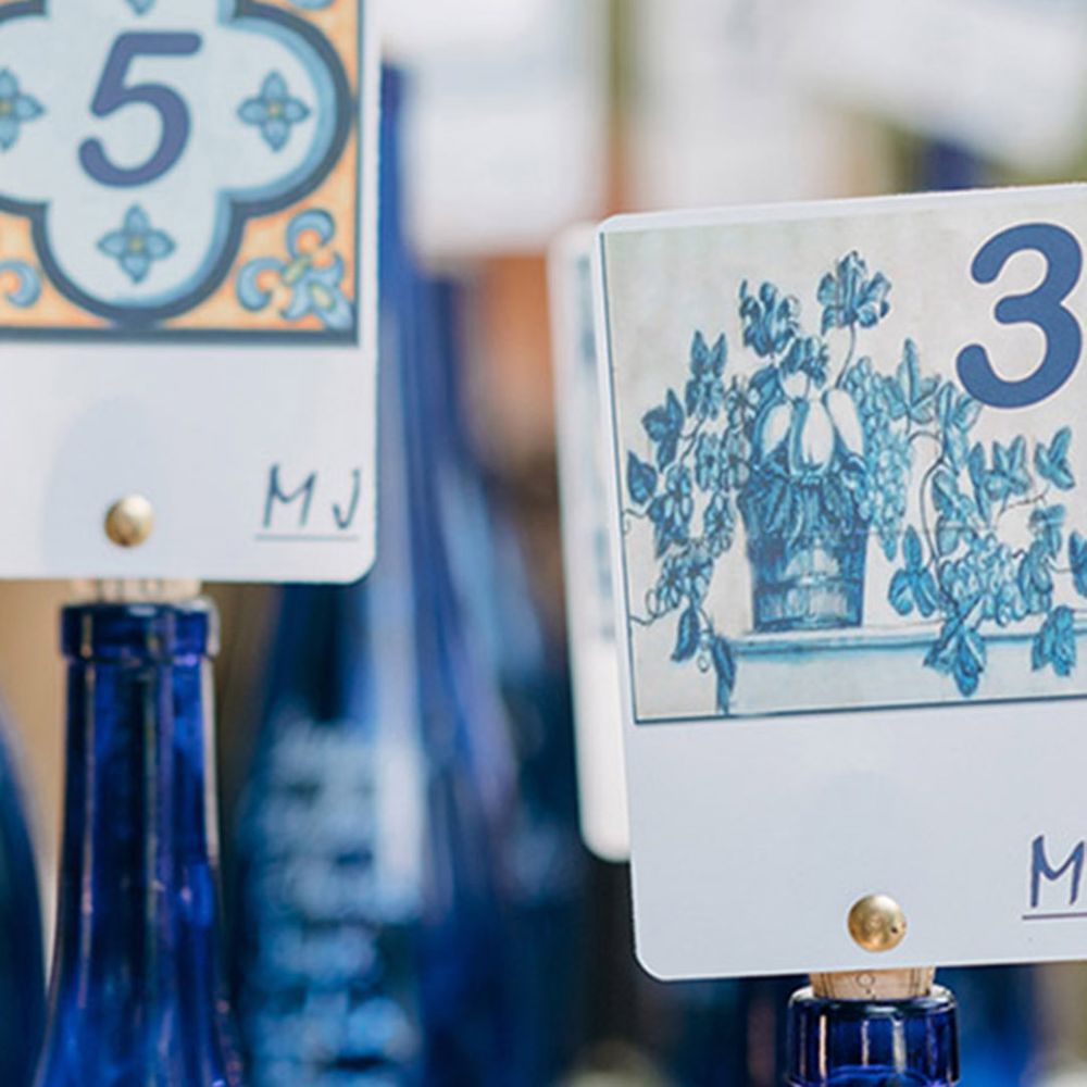 Wedding table name sign in blue colour bottles to look like blue mosaic 