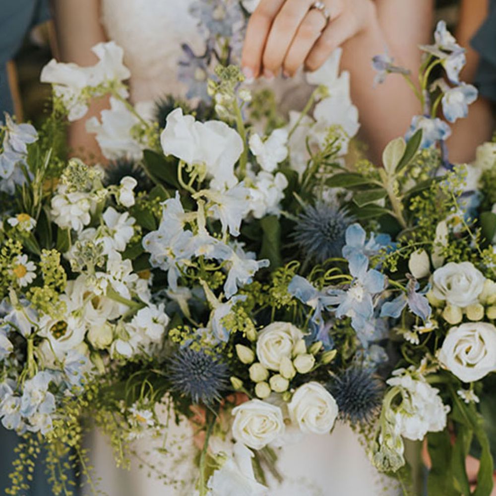 Thistles with white and blue wedding flowers in bouquet 
