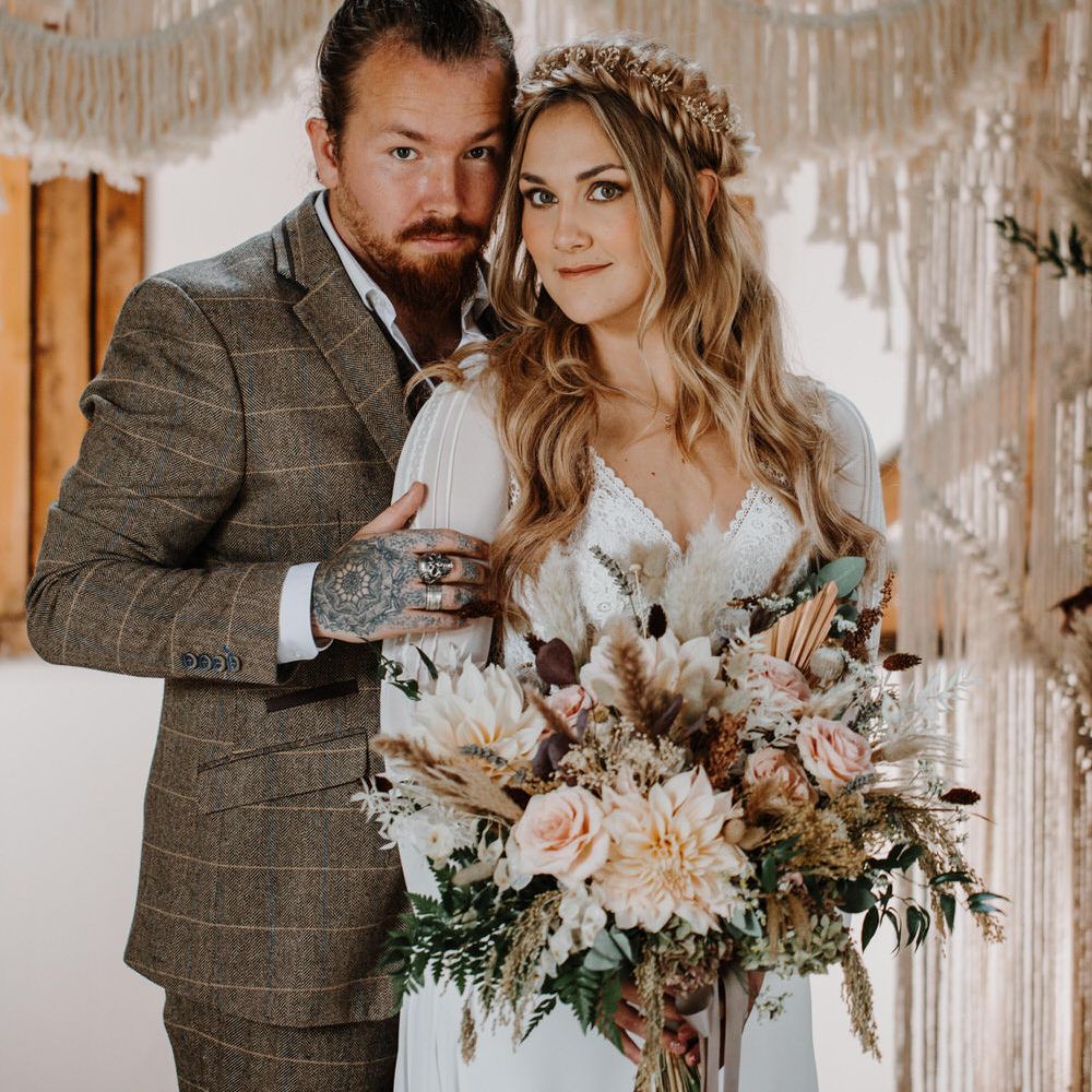 Boho luxe wedding theme for barn wedding with macrame backdrop