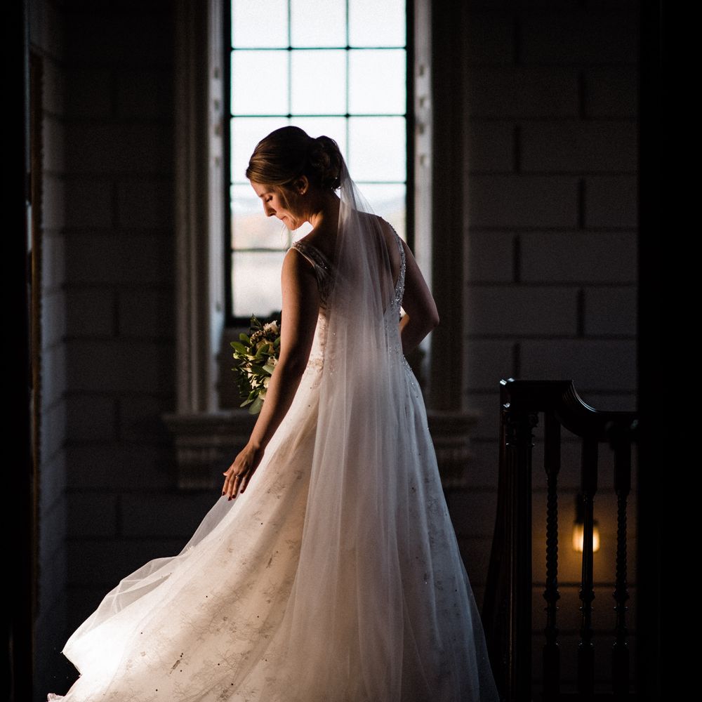 Bride has her back to the camera in Justin Alexander bridal gown