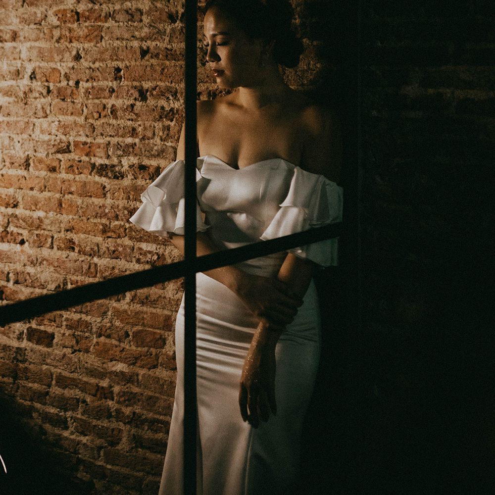 Beautiful bride in an off the shoulder wedding dress with puff sleeves and bridal crown 