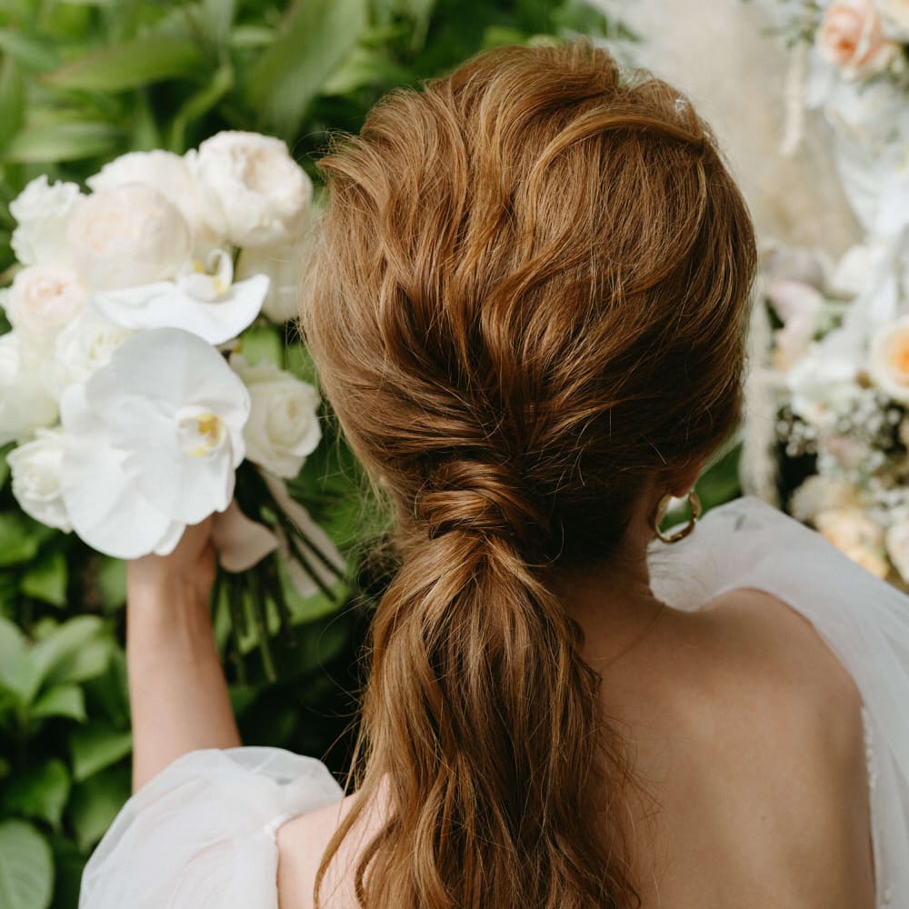 Ginger bride with relaxed waves low ponytail for boho wedding hair