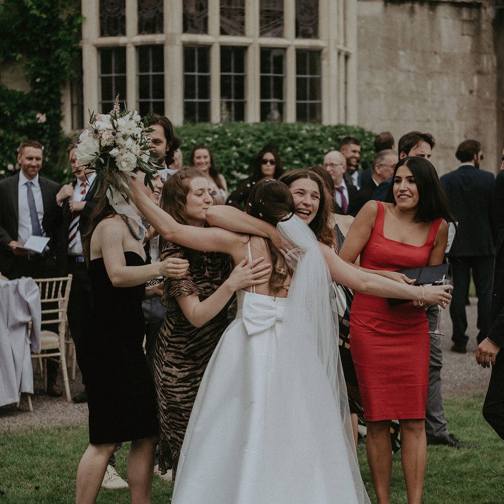 Bride goes to hug emotional friends after wedding ceremony