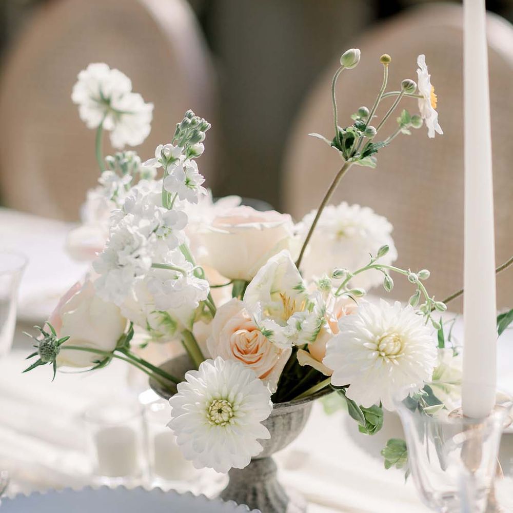 Pastel florals line simple table for outdoor reception