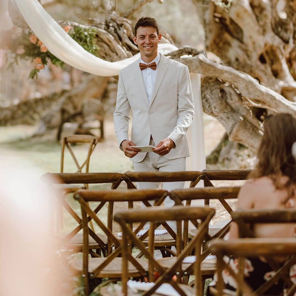 Smiling groom awaits the arrival of the bride 