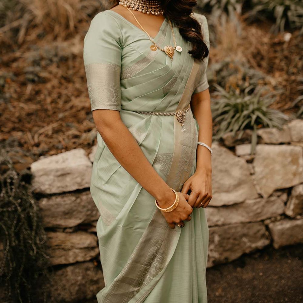 Bride in mint green saree with golden and pearl jewellery and golden embellishments at The Petersham Hotel