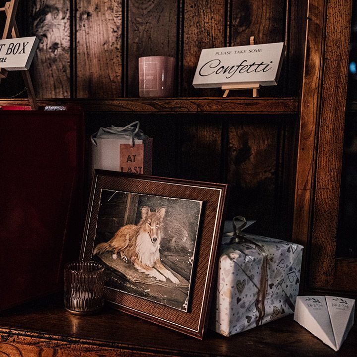 Wedding post box for guest cards on wooden shelves with sign for confetti