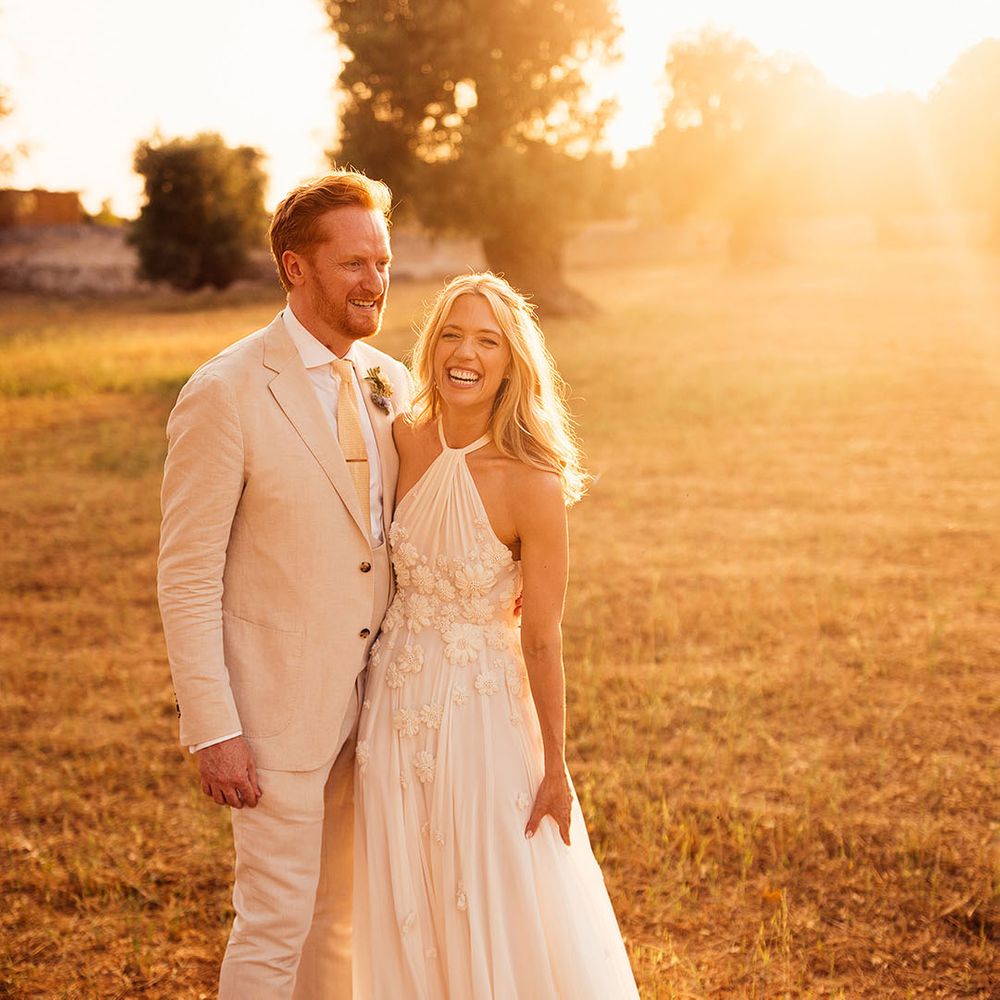 Golden hour couple portrait of the bride in an Emma Beaumont wedding dress and the groom in a cream suit 