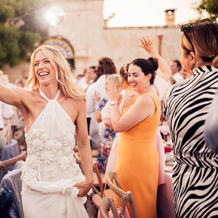 Bride high fives a wedding guest