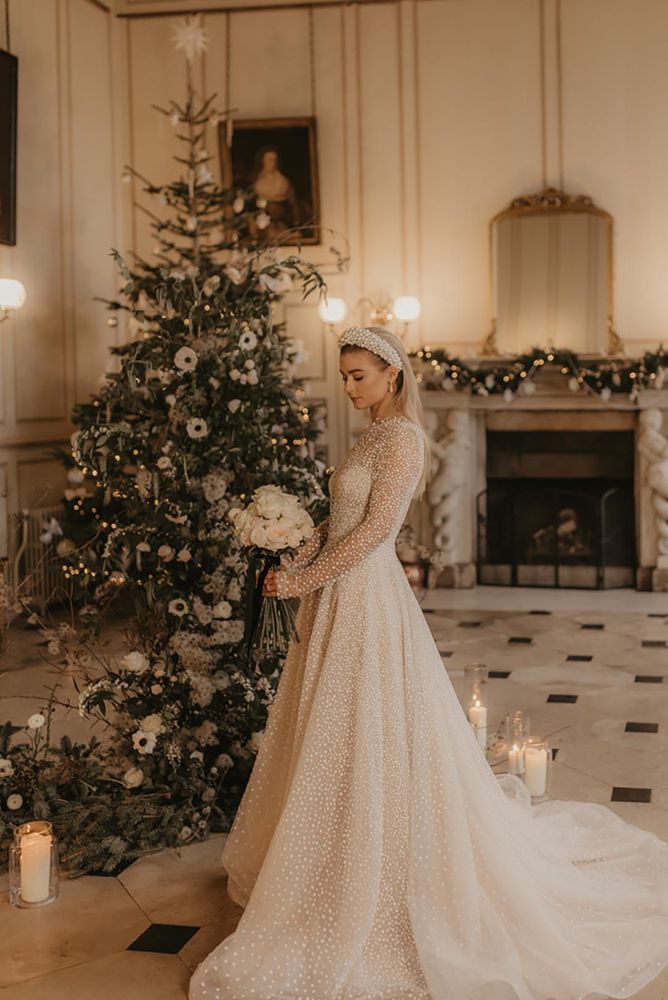 december bride in wedding dress with long sleeves