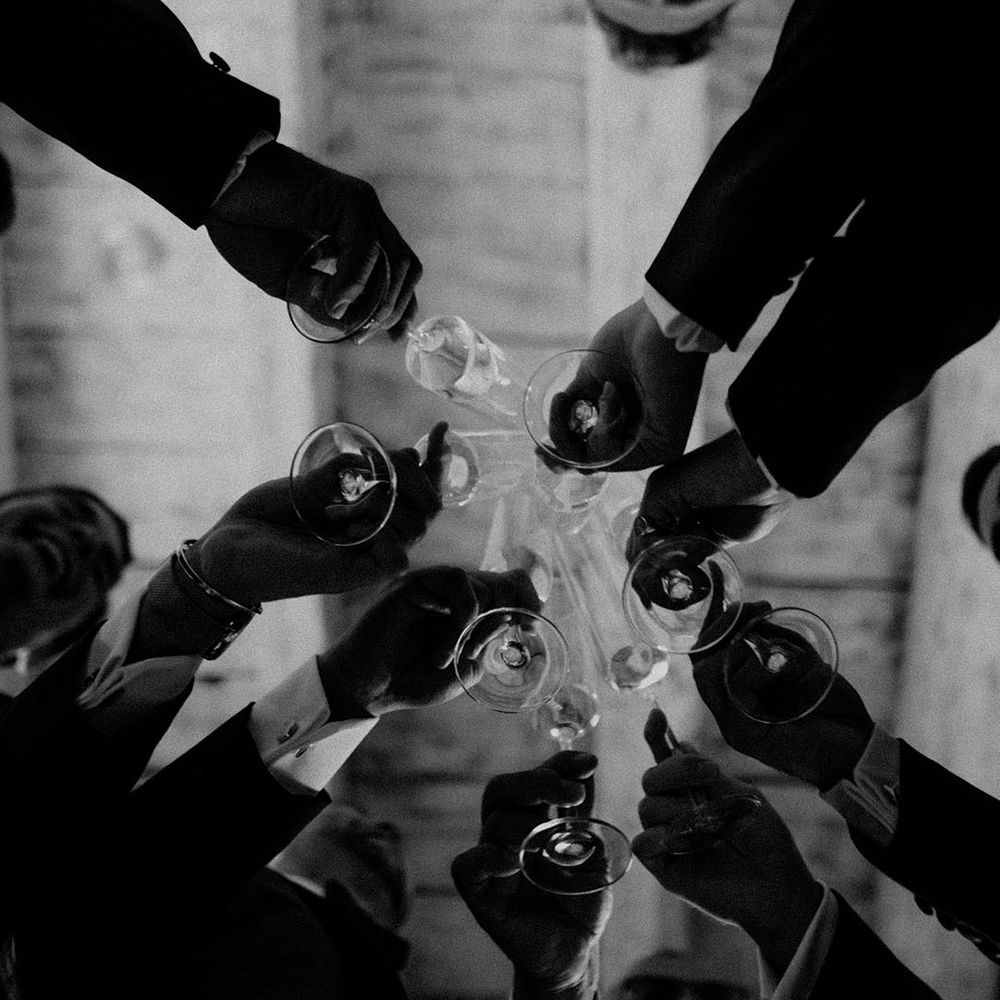 Wedding guests all cheers together 